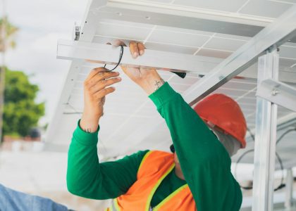 construction worker holding on a purlin